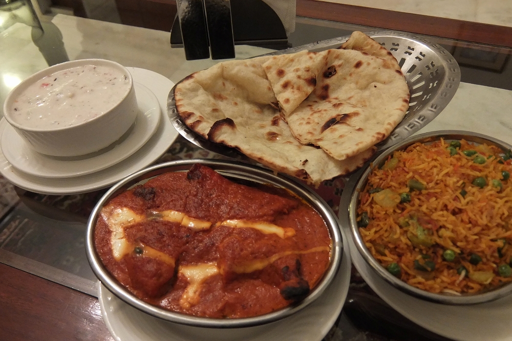 Room Service Meal from Amar Mahal Hotel in Orchha includes Butter Chicken, Cheese Nan, Raita and Saffron Rice